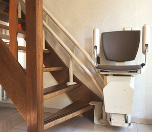 Automatic stairlift on staircase for elderly or disability in a house,